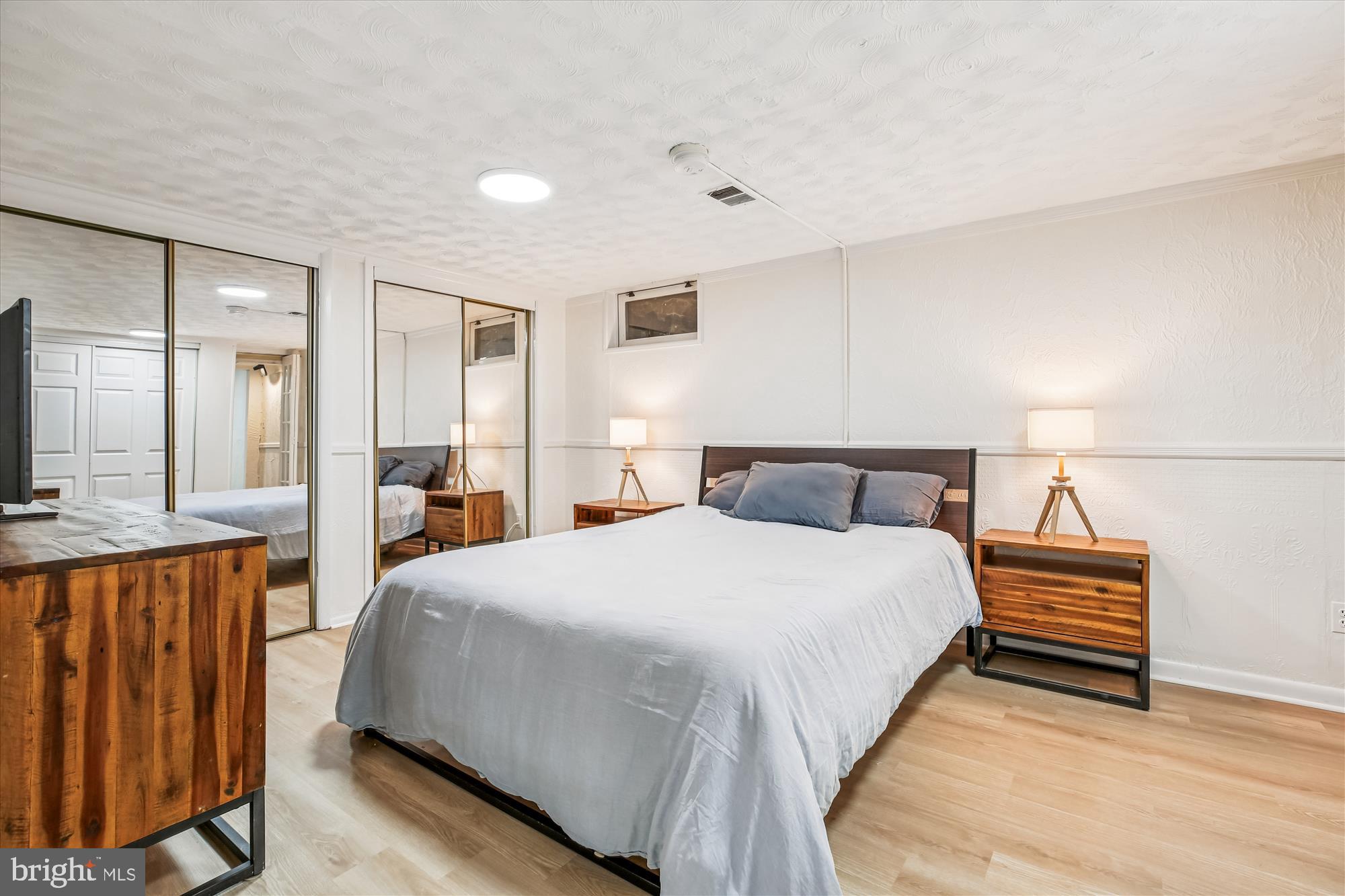 4805 Topping Road Rockville, MD 20852 - Photo 27 of 38 a spacious bedroom with a bed a mirror and lamp