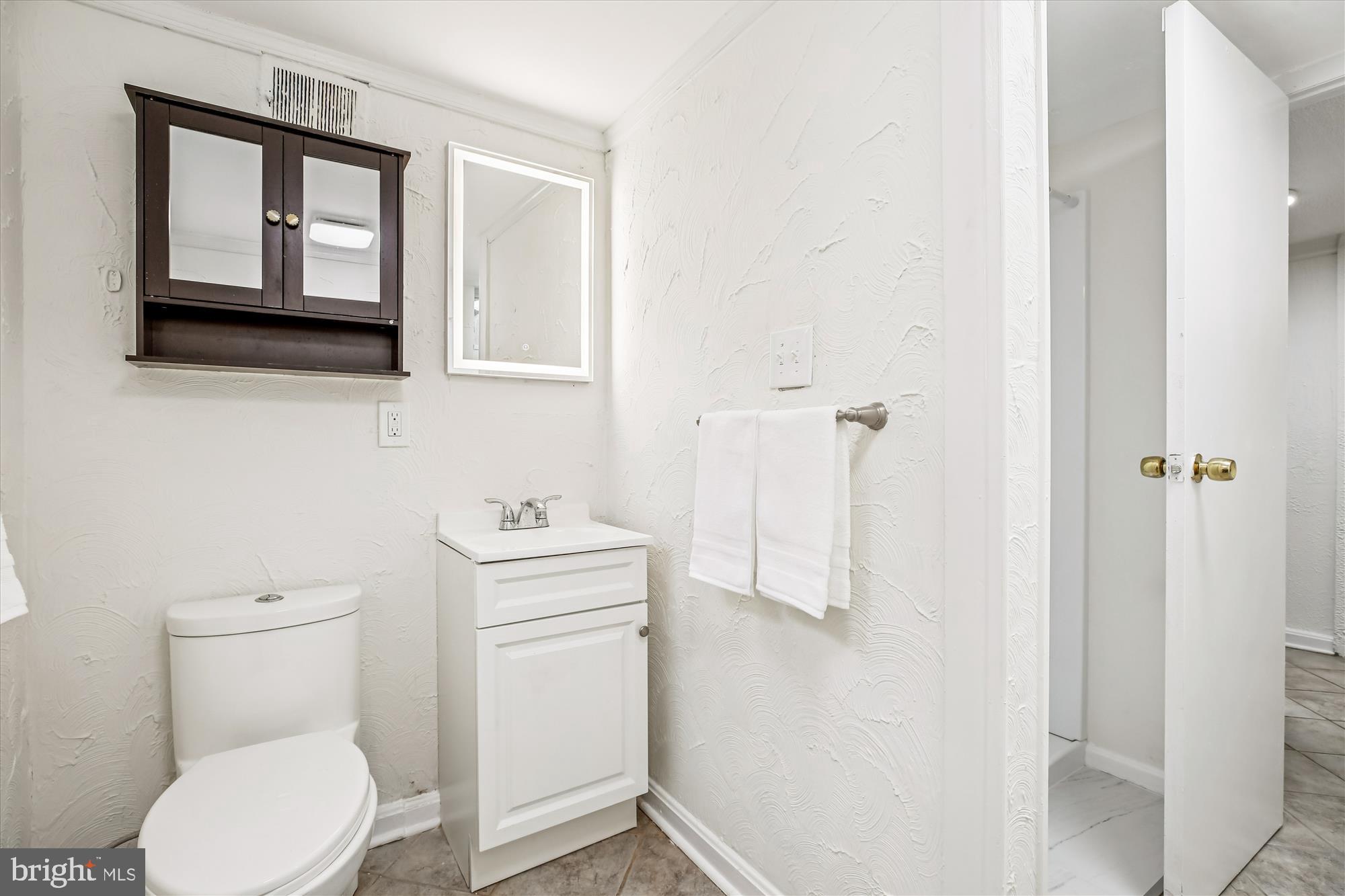 4805 Topping Road Rockville, MD 20852 - Photo 29 of 38 a white toilet sitting next to a bathroom sink