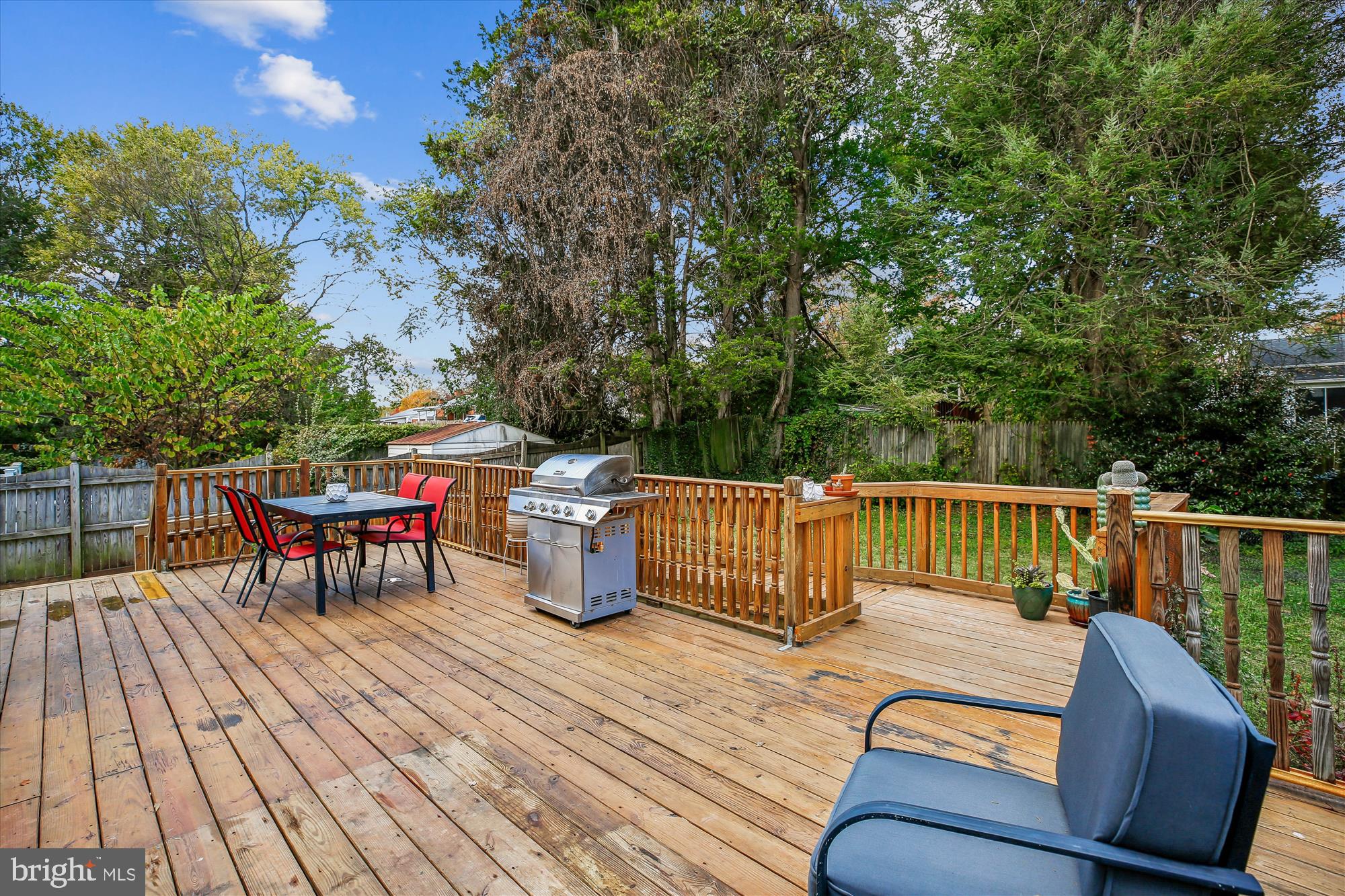 4805 Topping Road Rockville, MD 20852 - Photo 32 of 38 a view of a roof deck with table and chairs couches and wooden fence