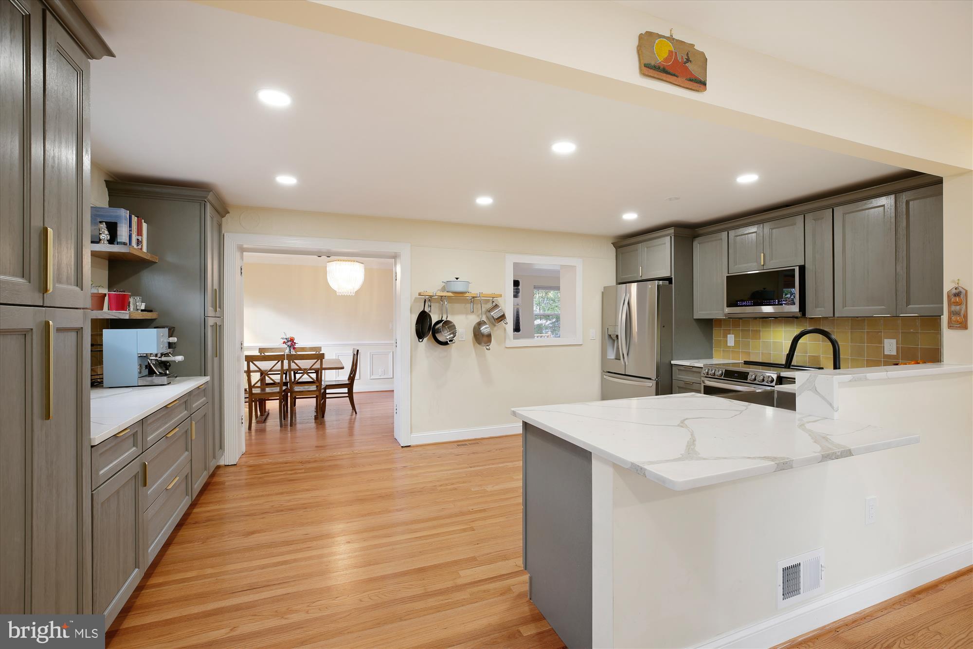 4805 Topping Road Rockville, MD 20852 - Photo 7 of 38 a kitchen with stainless steel appliances a microwave a stove a sink a refrigerator and chairs
