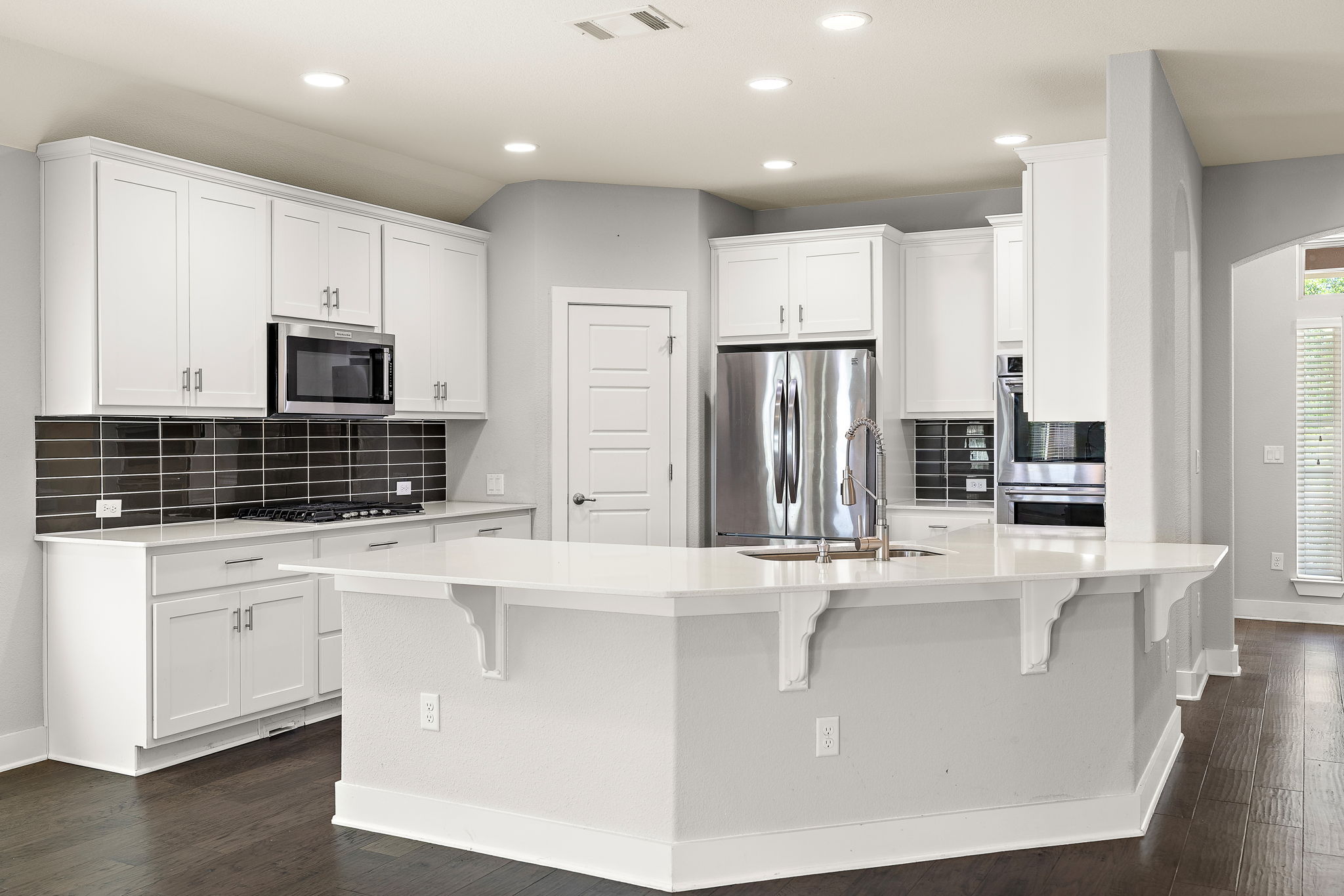7520 Kinross Trail Austin, TX 78754 - Photo 11 of 37 Kitchen with backsplash, stainless steel appliances, white cabinetry, and recessed lighting