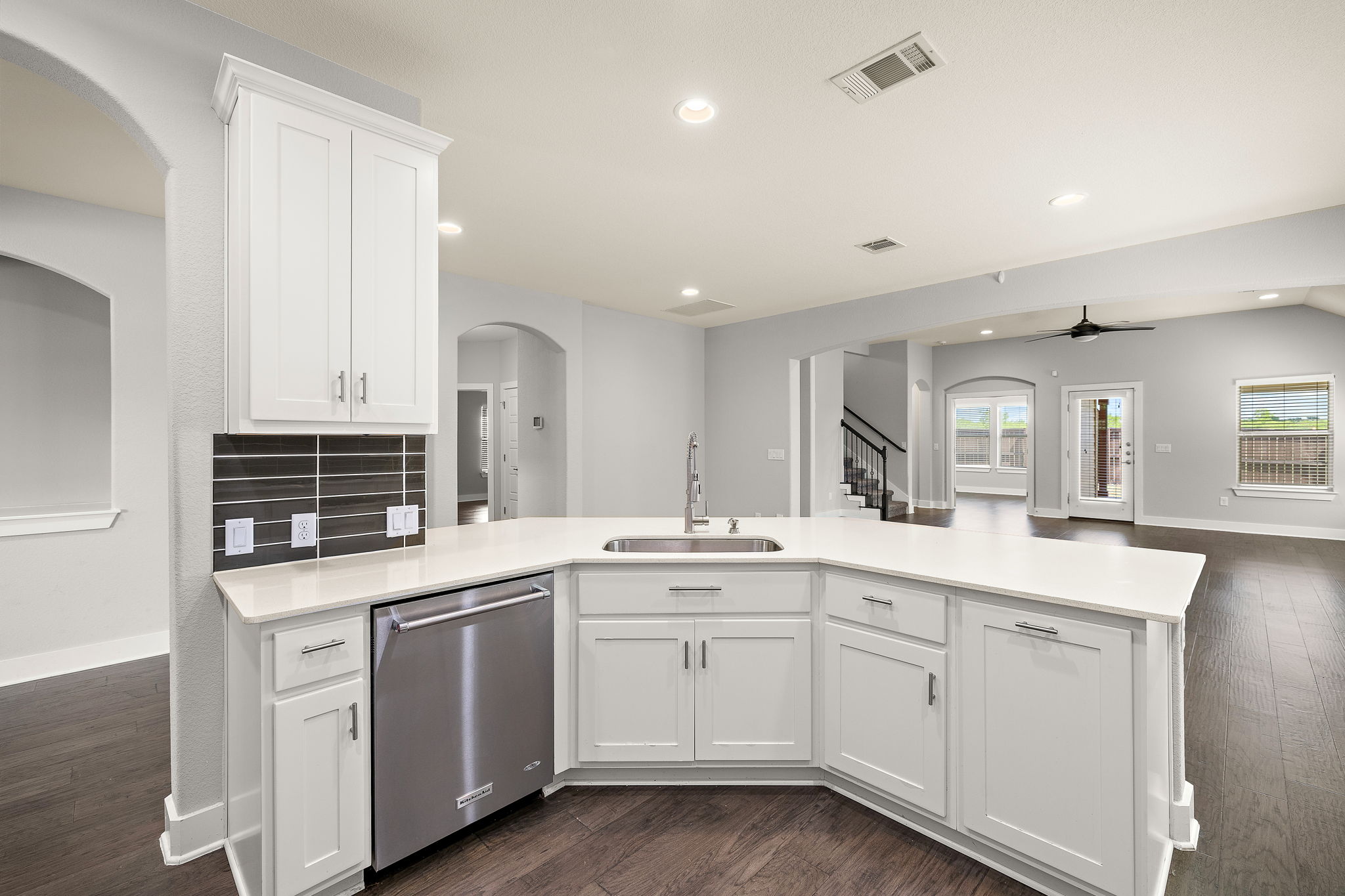 7520 Kinross Trail Austin, TX 78754 - Photo 14 of 37 Kitchen with arched walkways, white cabinetry, dark wood-type flooring, and recessed lighting