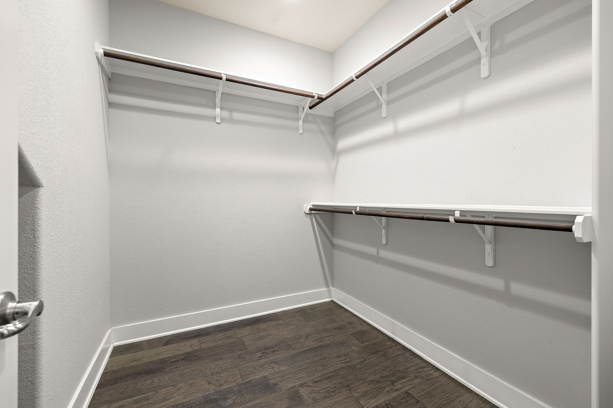 7520 Kinross Trail Austin, TX 78754 - Photo 18 of 37 Walk in closet with dark wood-type flooring