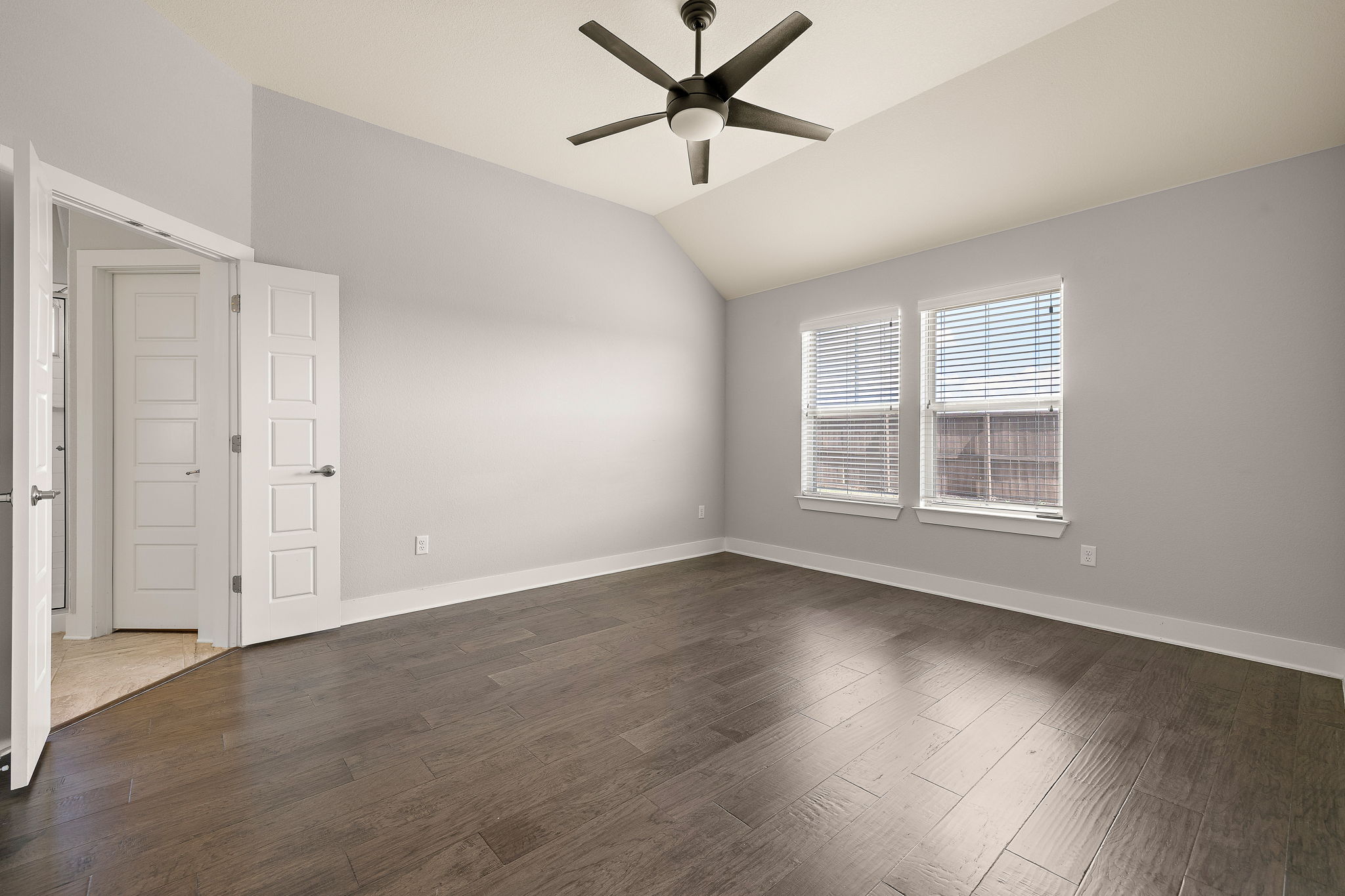 7520 Kinross Trail Austin, TX 78754 - Photo 20 of 37 Unfurnished room with ceiling fan, lofted ceiling, and dark wood-style floors