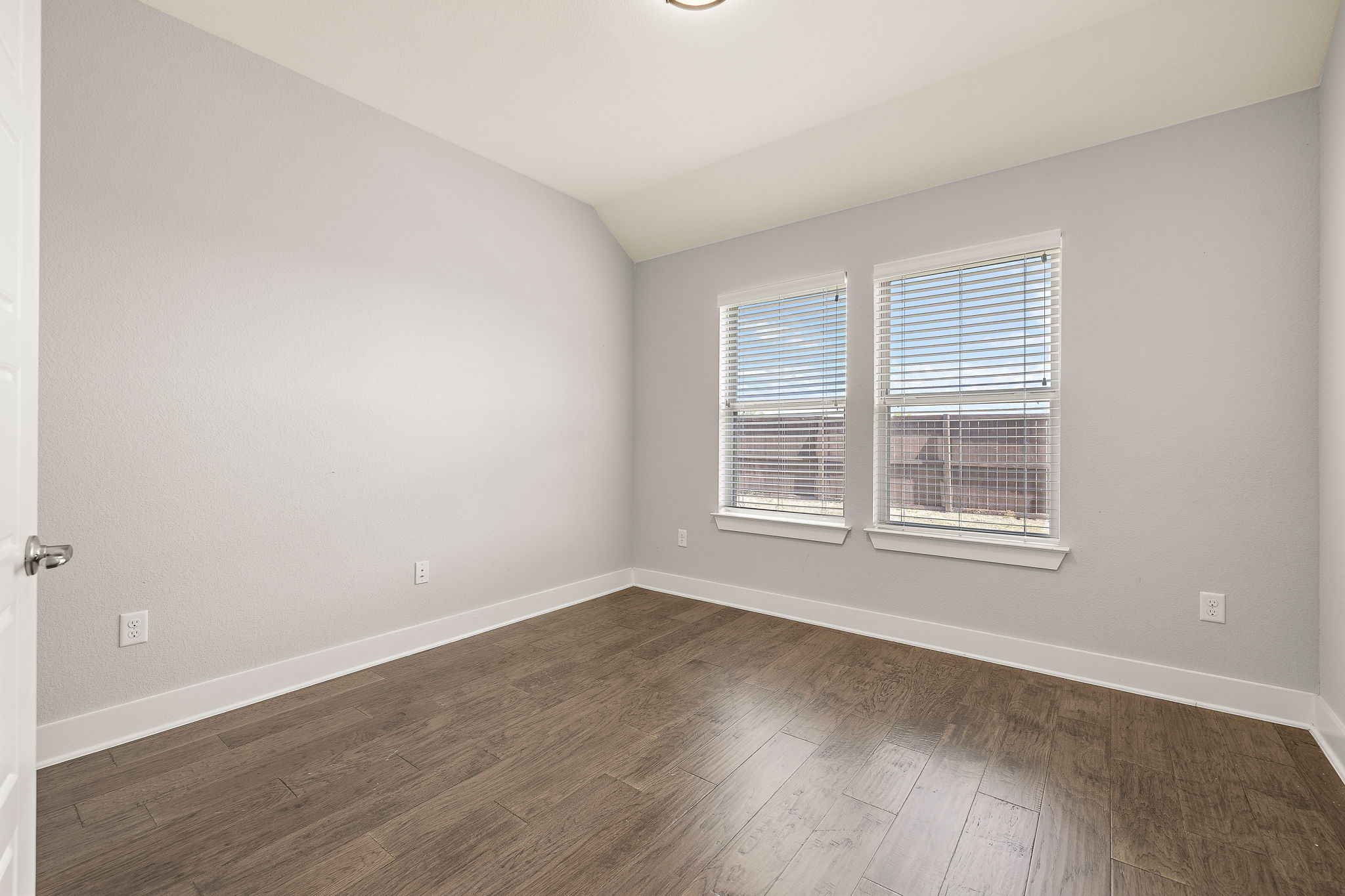 7520 Kinross Trail Austin, TX 78754 - Photo 22 of 37 Unfurnished room with lofted ceiling and dark wood-style flooring