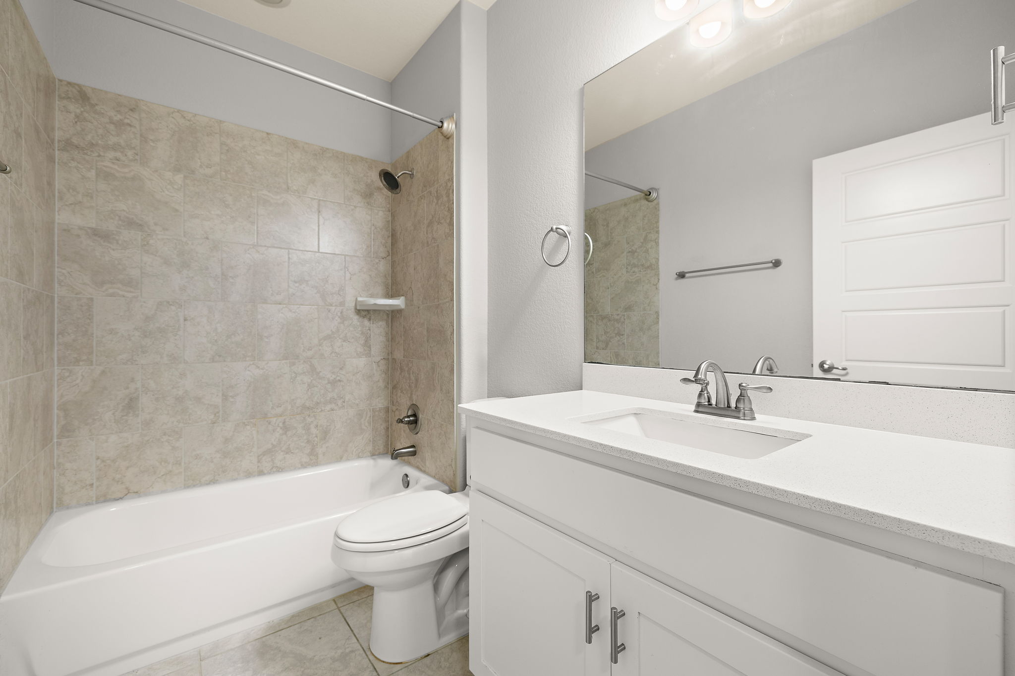 7520 Kinross Trail Austin, TX 78754 - Photo 25 of 37 Full bathroom featuring vanity, bathing tub / shower combination, and light tile patterned floors