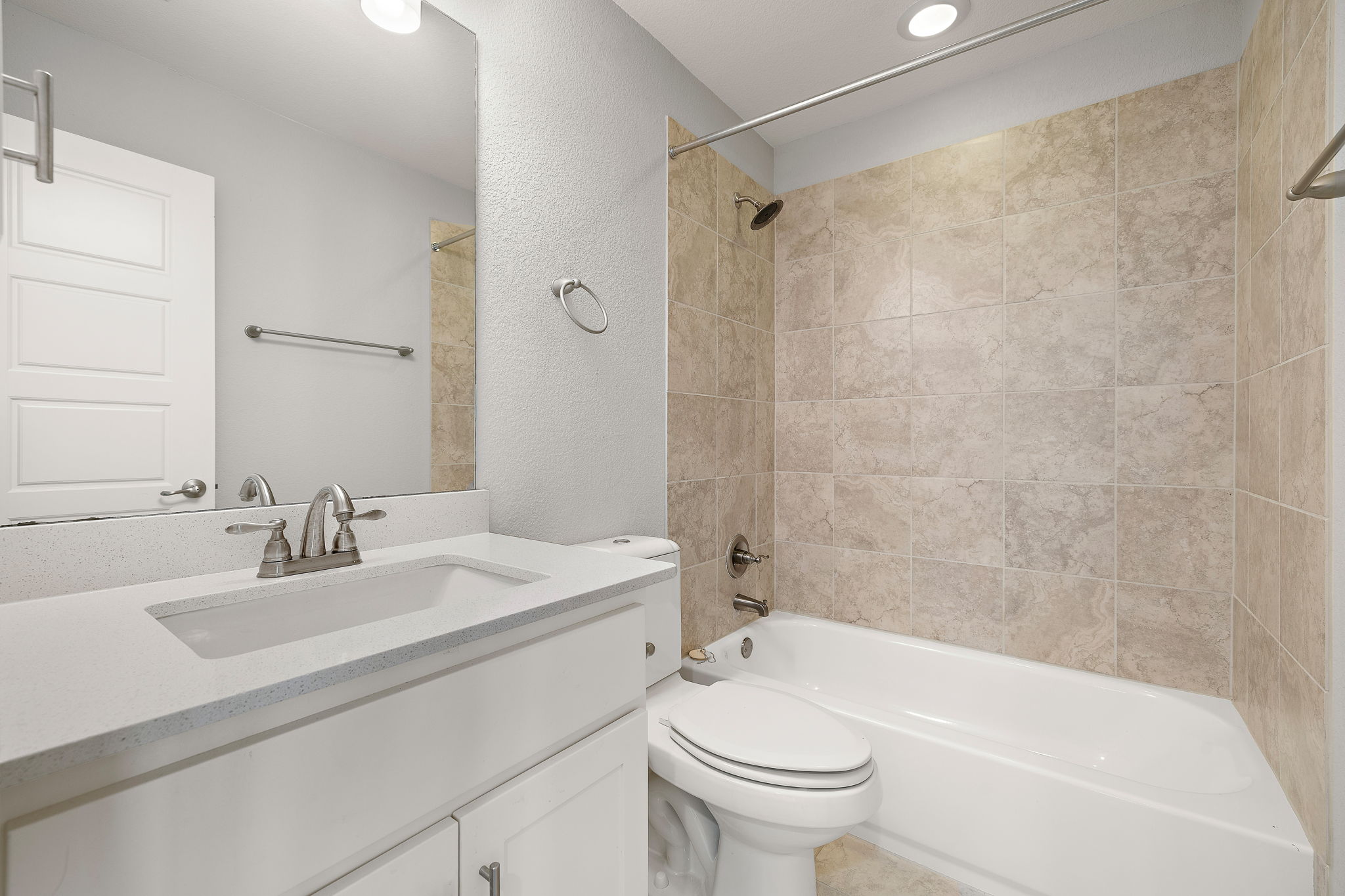 7520 Kinross Trail Austin, TX 78754 - Photo 30 of 37 Full bathroom featuring vanity, a textured wall, and shower / tub combination