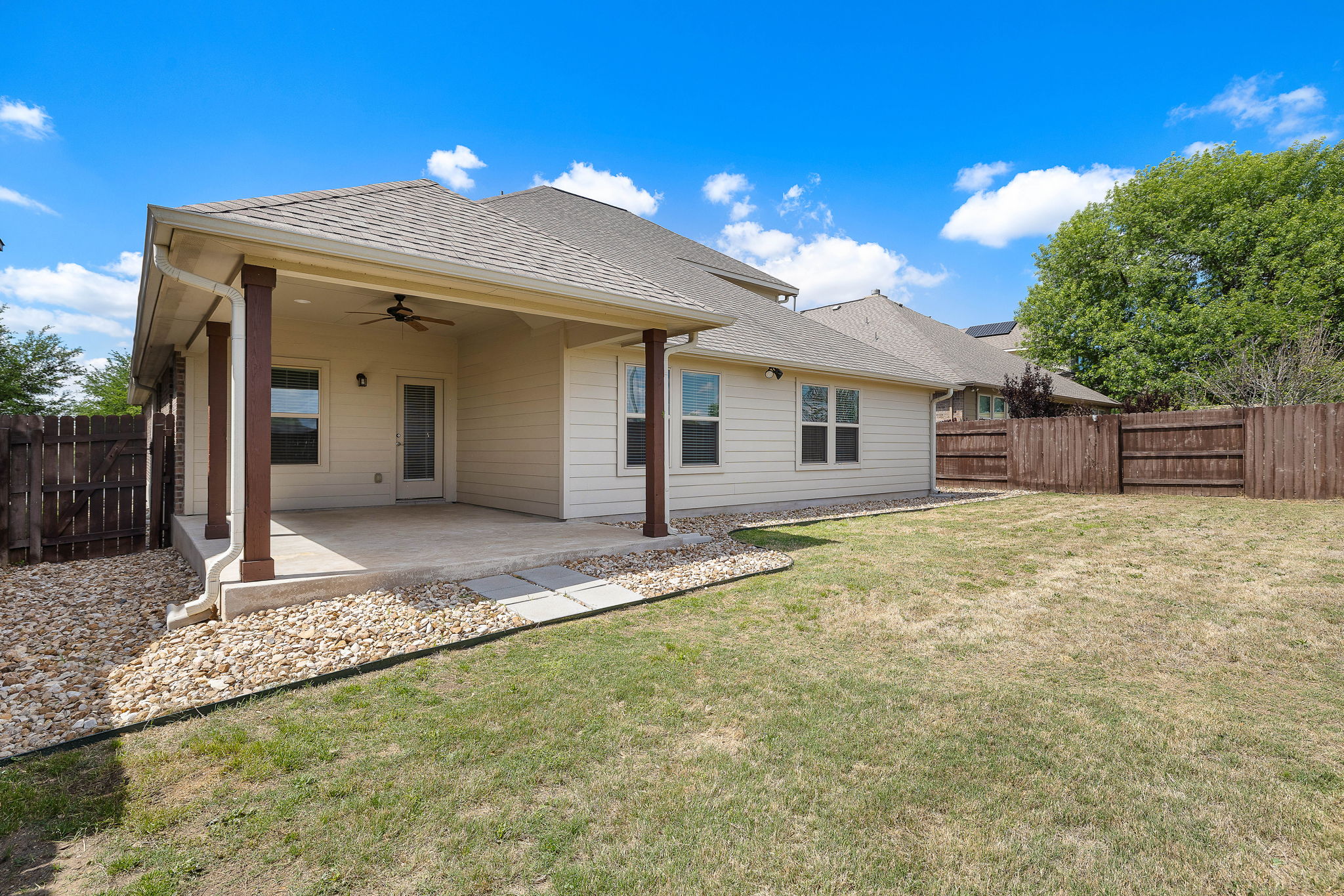 7520 Kinross Trail Austin, TX 78754 - Photo 32 of 37 Rear view of house with a ceiling fan, a patio area, a fenced backyard, and roof with shingles