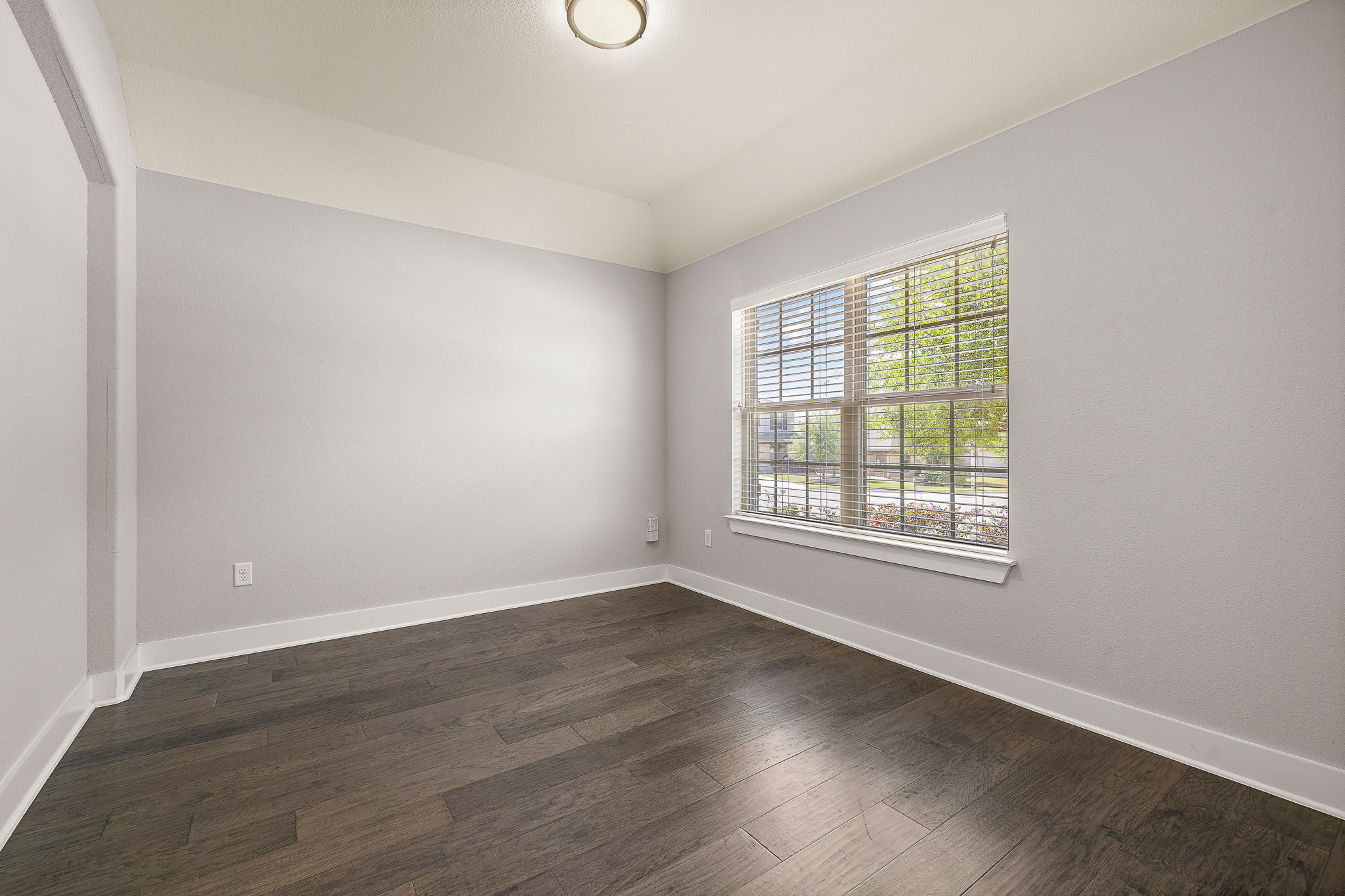 7520 Kinross Trail Austin, TX 78754 - Photo 5 of 37 Spare room featuring baseboards and dark wood-type flooring