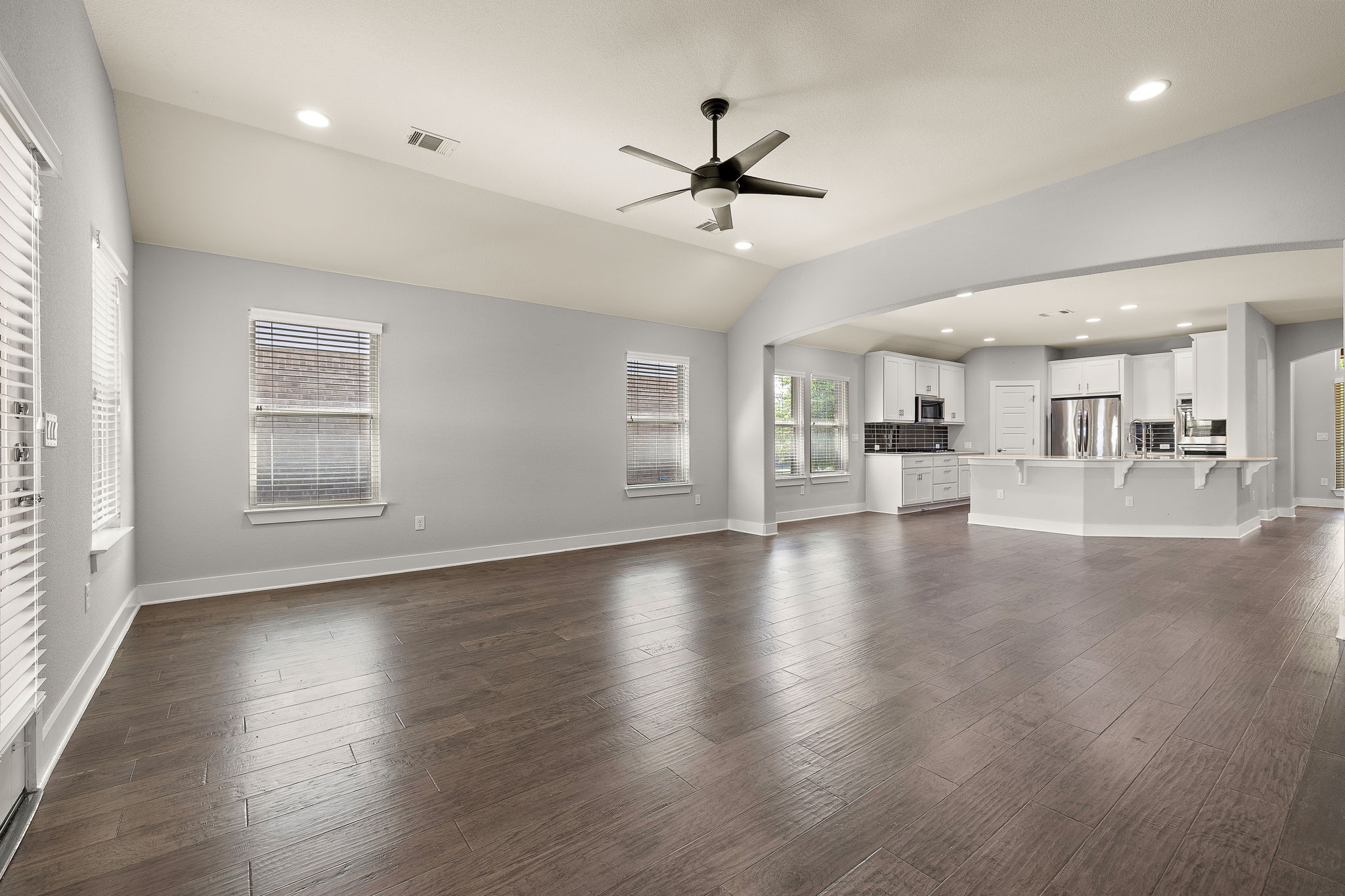 7520 Kinross Trail Austin, TX 78754 - Photo 6 of 37 Unfurnished living room featuring a ceiling fan, recessed lighting, dark wood finished floors, and lofted ceiling