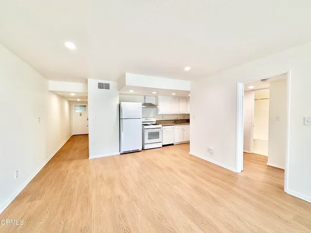 a view of a kitchen with a stove cabinets and wooden floor