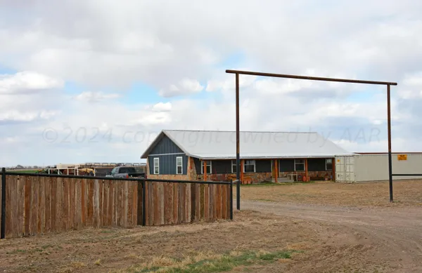 a front view of a house with wooden fence
