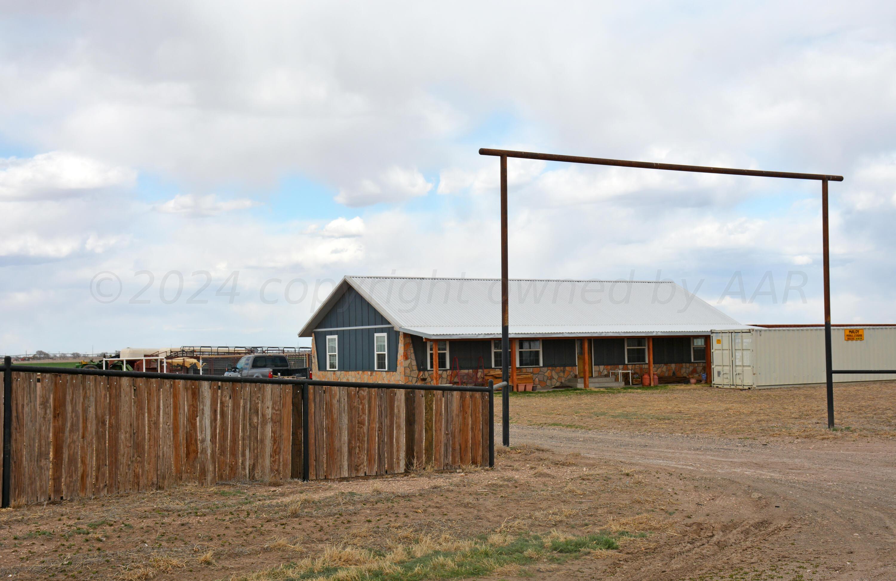 a front view of a house with wooden fence