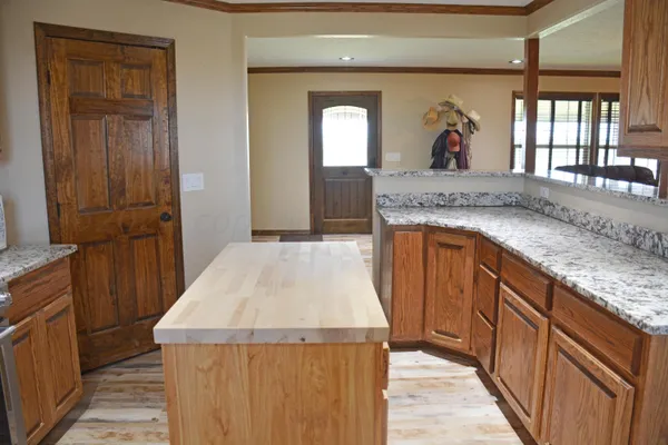 a kitchen with a sink and a wooden floor