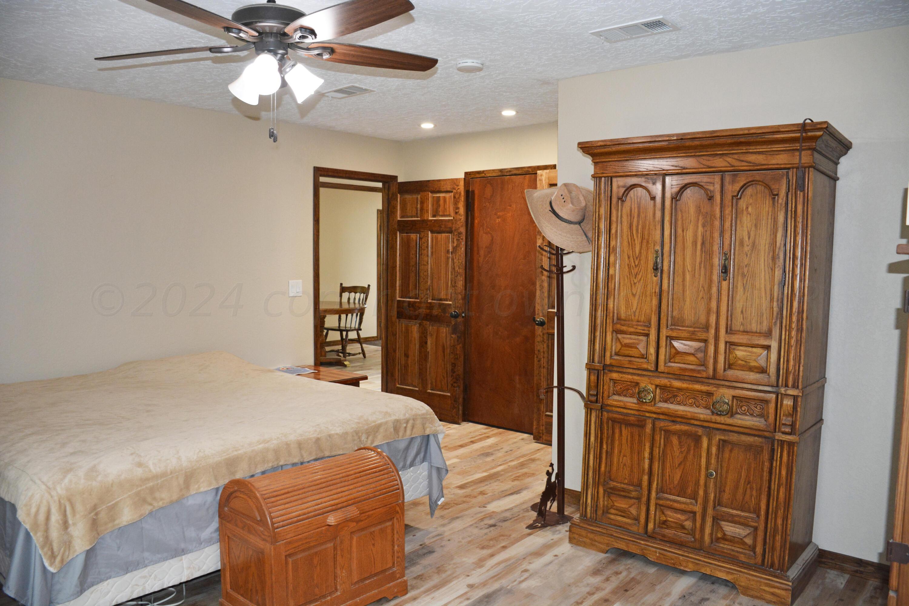 1159 Fm 1760 Muleshoe, TX 79347 - Photo 19 of 34 a bedroom with a bed and a ceiling fan