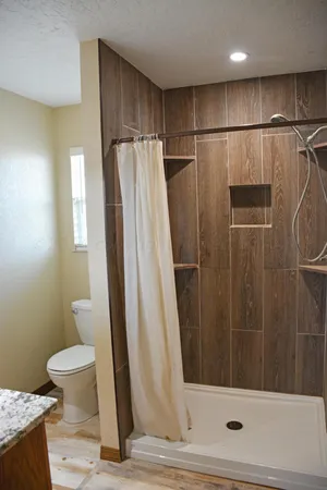 a bathroom with a shower and a toilet