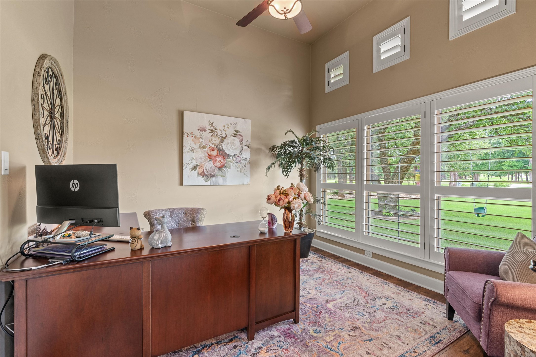 104 Adobe Cove Georgetown, TX 78633 - Photo 5 of 40 An inviting home office with warm tones features large windows providing views of mature trees.