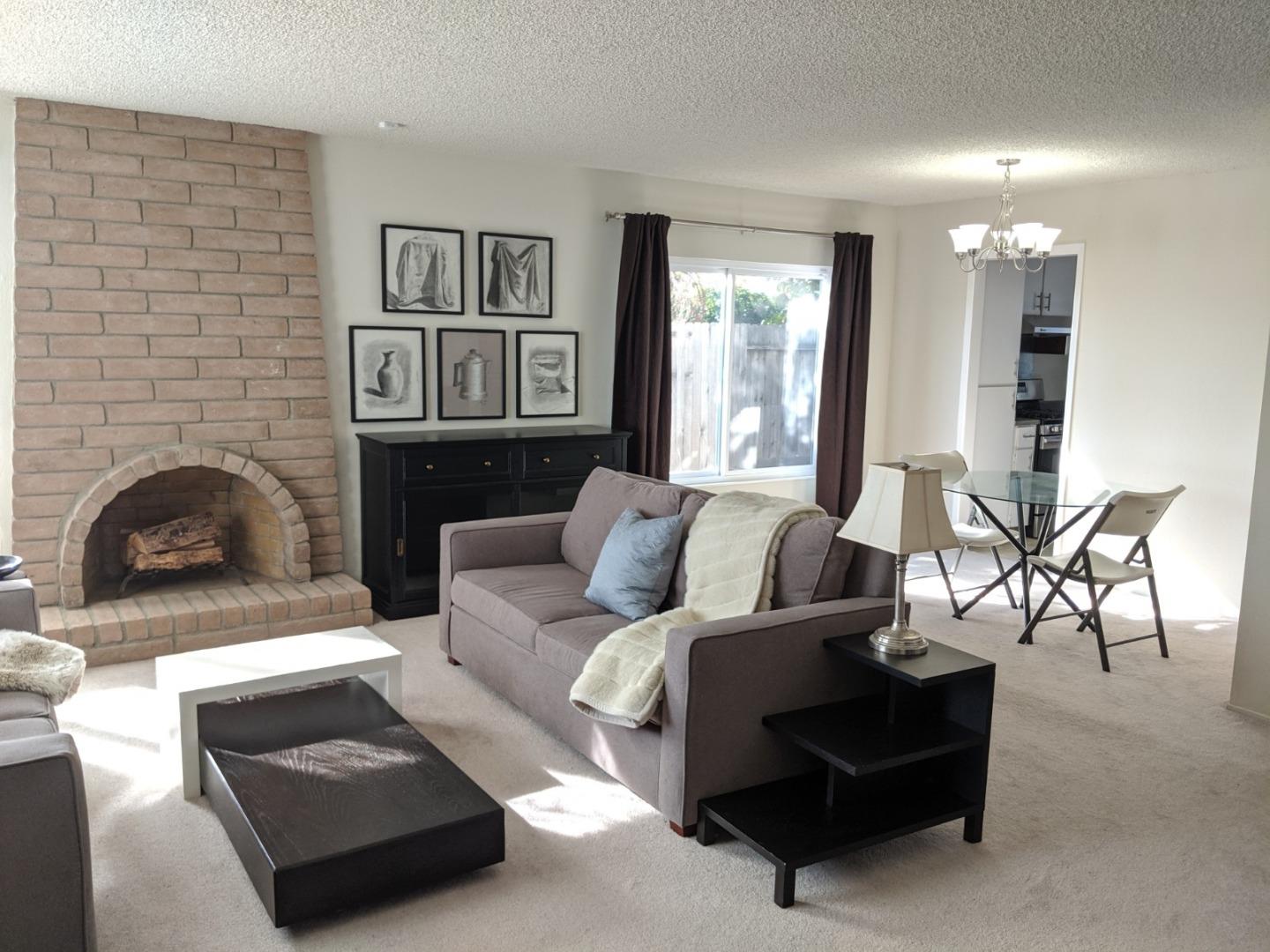 965 Viewpointe Boulevard Rodeo, CA 94572 - Photo 3 of 10 a living room with furniture and a fireplace