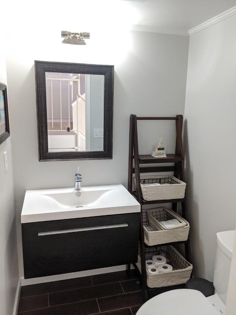 965 Viewpointe Boulevard Rodeo, CA 94572 - Photo 4 of 10 a bathroom with a toilet sink and mirror