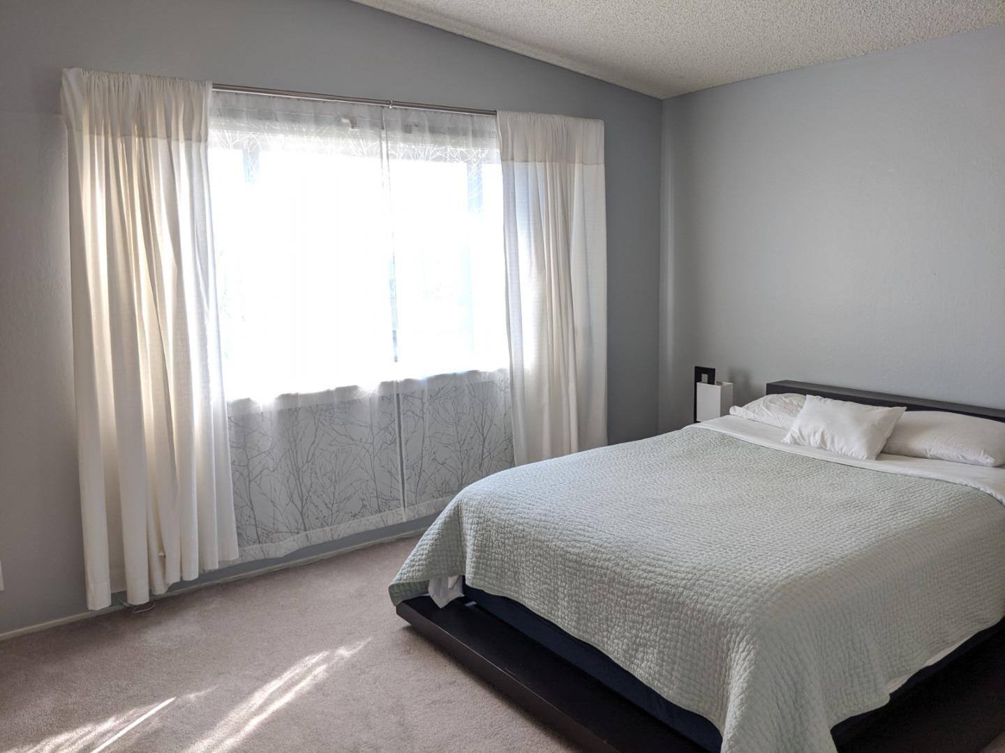 965 Viewpointe Boulevard Rodeo, CA 94572 - Photo 6 of 10 a bedroom with a bed and window