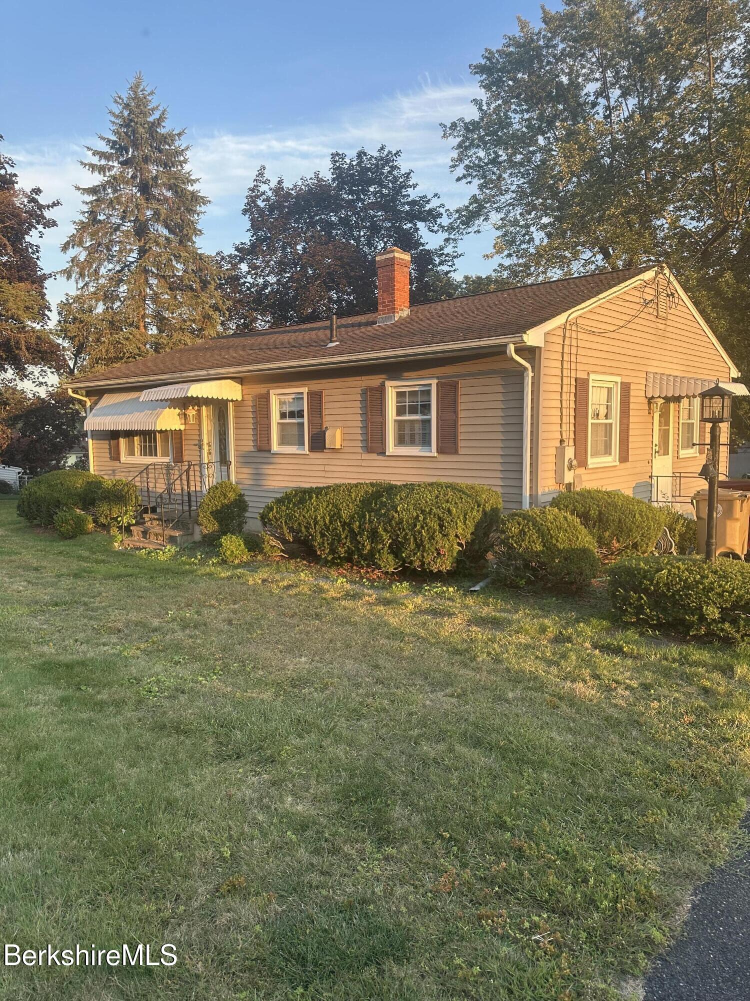 a front view of a house with a garden