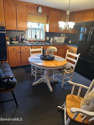 a kitchen with a table chairs and a kitchen view