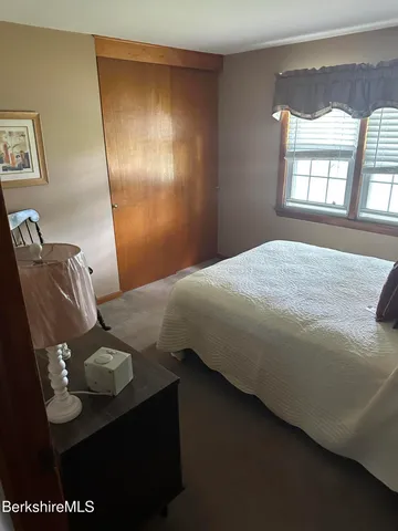 a bedroom with a bed and dresser
