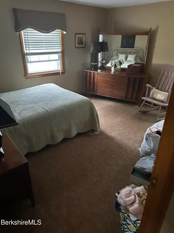 a bedroom with a bed furniture and window