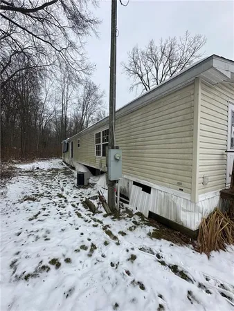 a view of a house with a yard covered in snow