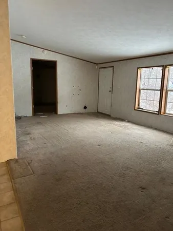 a view of an empty room with a fireplace