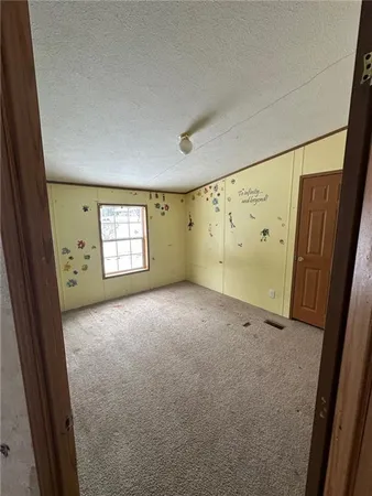 a view of an empty room and a window