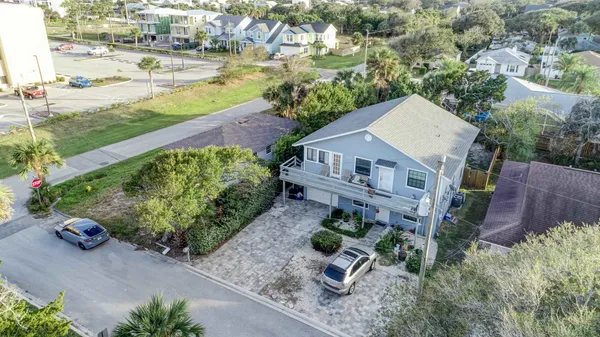 an aerial view of a house with a yard and lake view