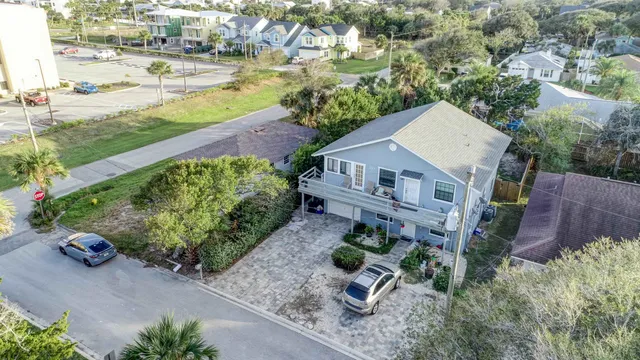 an aerial view of a house with a yard and lake view