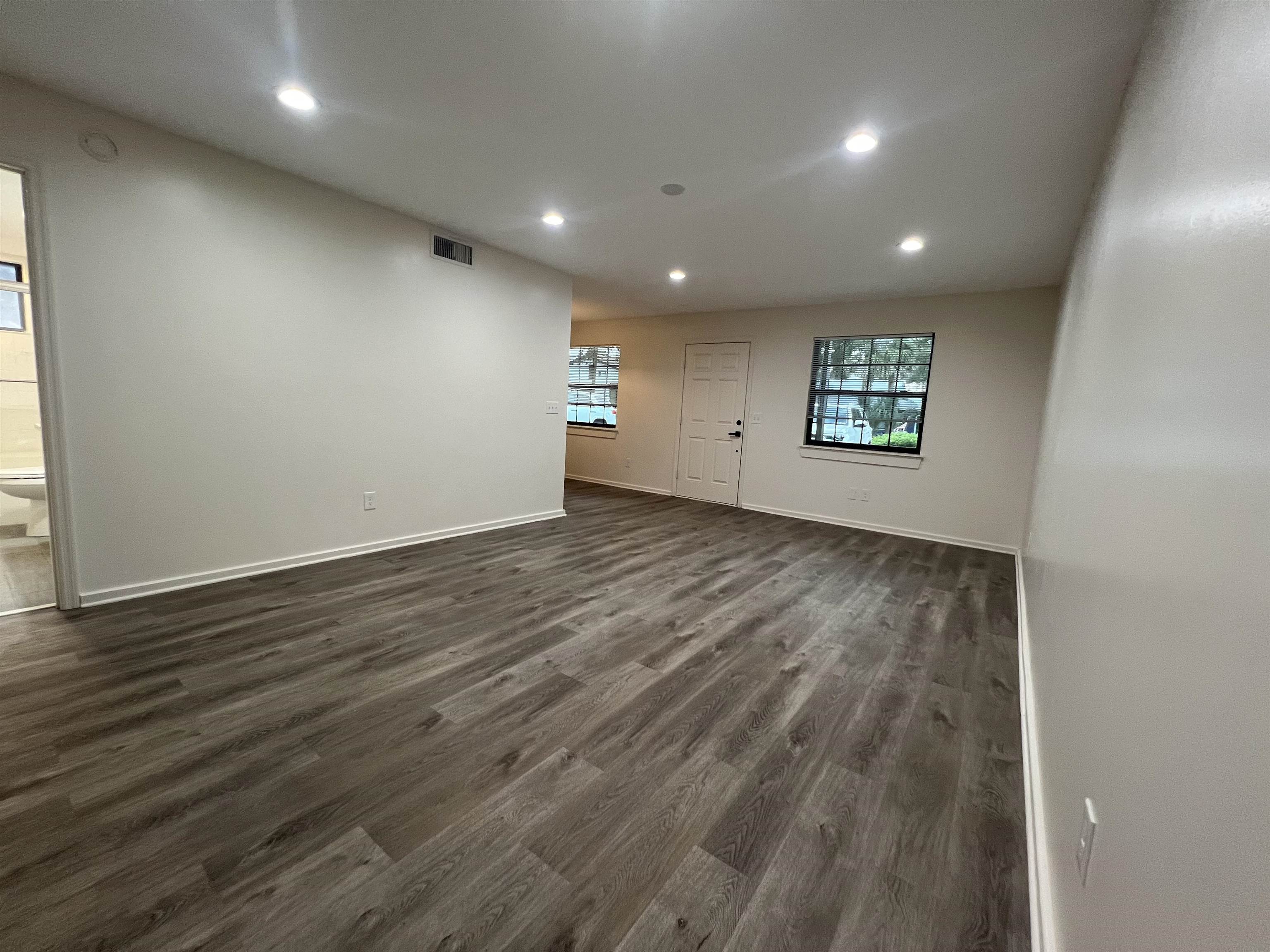 203 6th Street, Unit A St. Augustine, FL 32080 - Photo 11 of 21 an empty room with wooden floor and windows