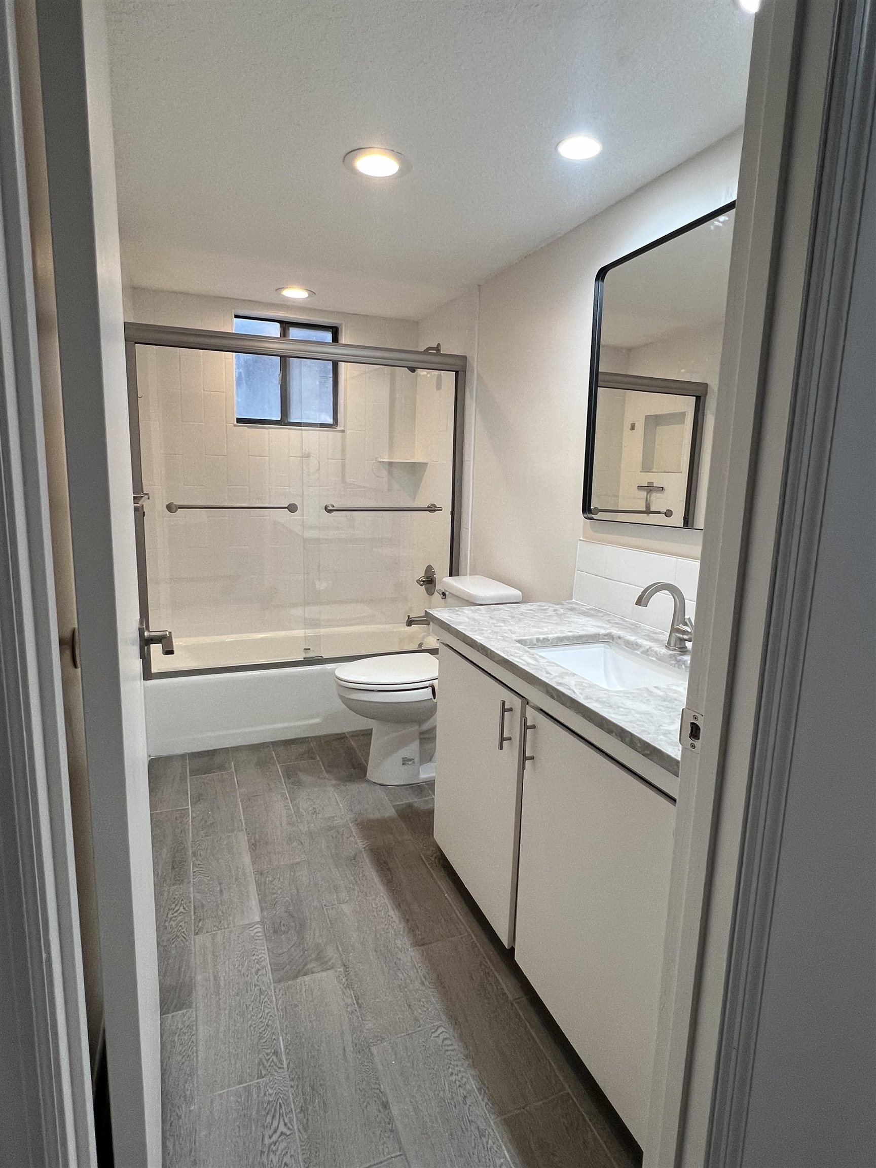 203 6th Street, Unit A St. Augustine, FL 32080 - Photo 2 of 21 a bathroom with a sink a toilet and mirror