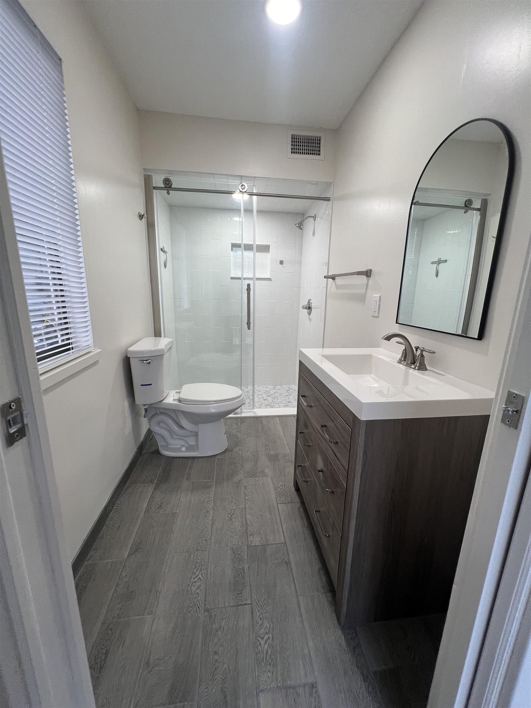 203 6th Street, Unit A St. Augustine, FL 32080 - Photo 6 of 21 a bathroom with a double vanity sink mirror and toilet