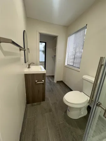 a bathroom with a toilet sink and mirror