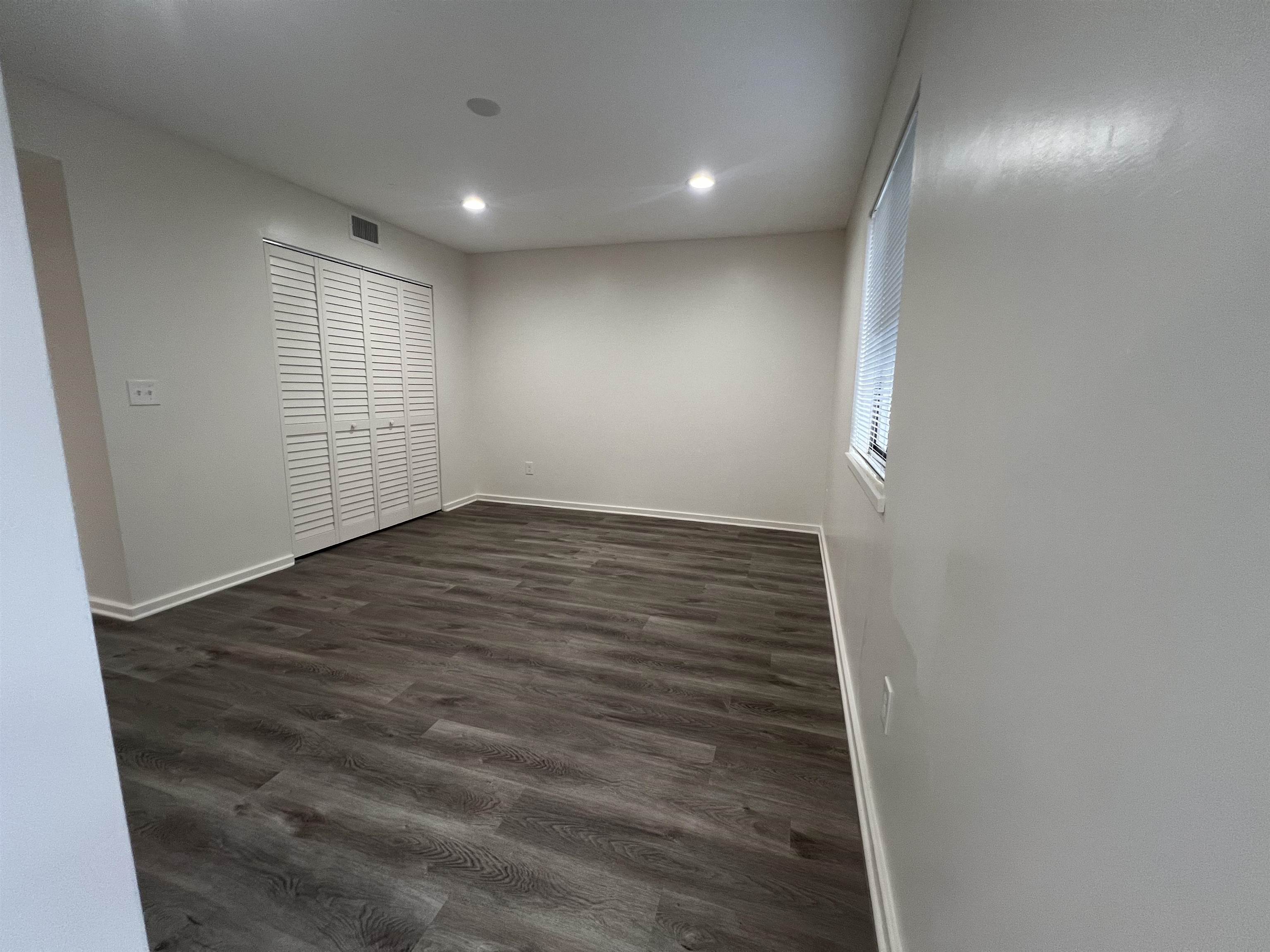 203 6th Street, Unit A St. Augustine, FL 32080 - Photo 8 of 21 an empty room with wooden floor & windows