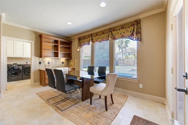 a view of a dining room with furniture and window