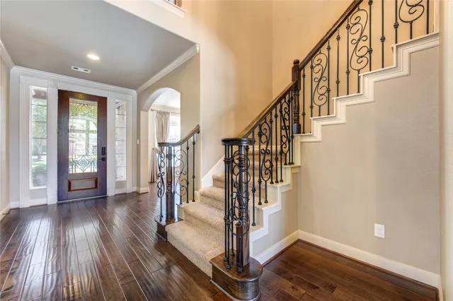 a view of entryway with wooden floor and stairs