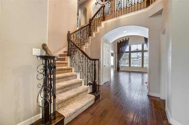 a view of entryway and hall with wooden floor