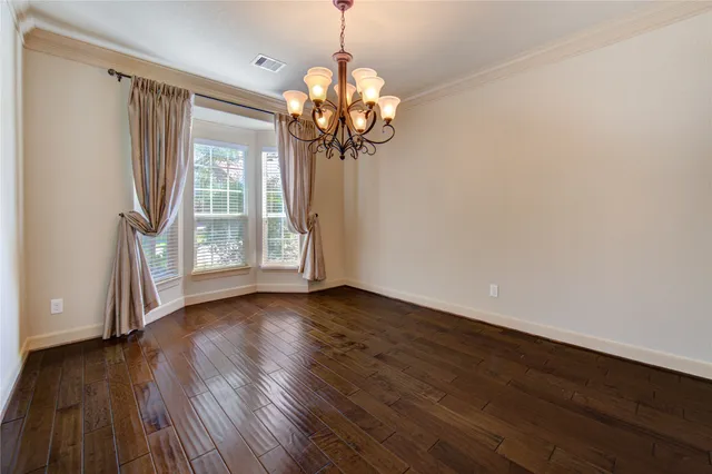 a view of a room with wooden floor and window