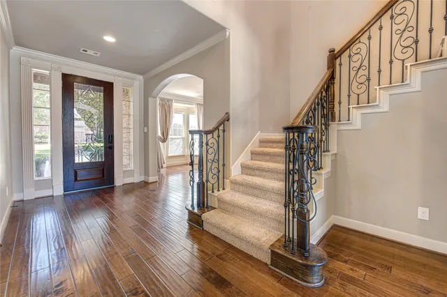 a view of staircase with wooden floor and a floor to ceiling window