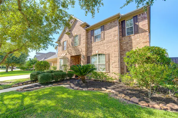 a view of a house with a yard and plants