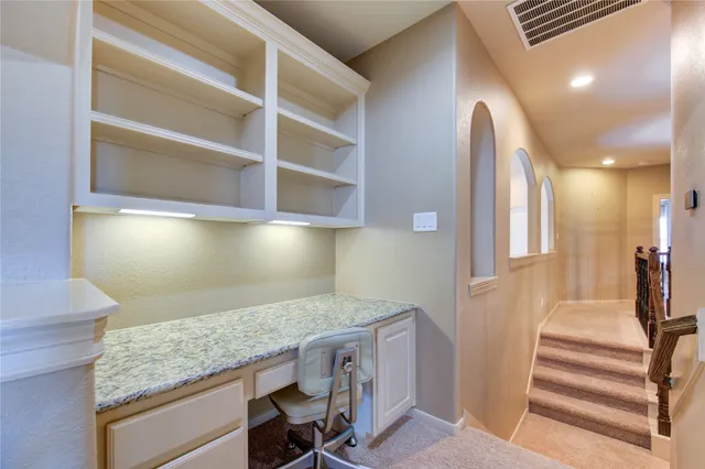 a view of a kitchen and an empty room