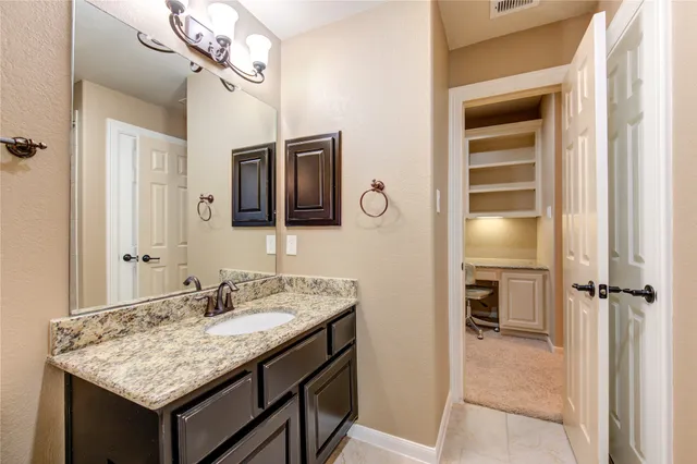 a bathroom with a sink a vanity and a mirror