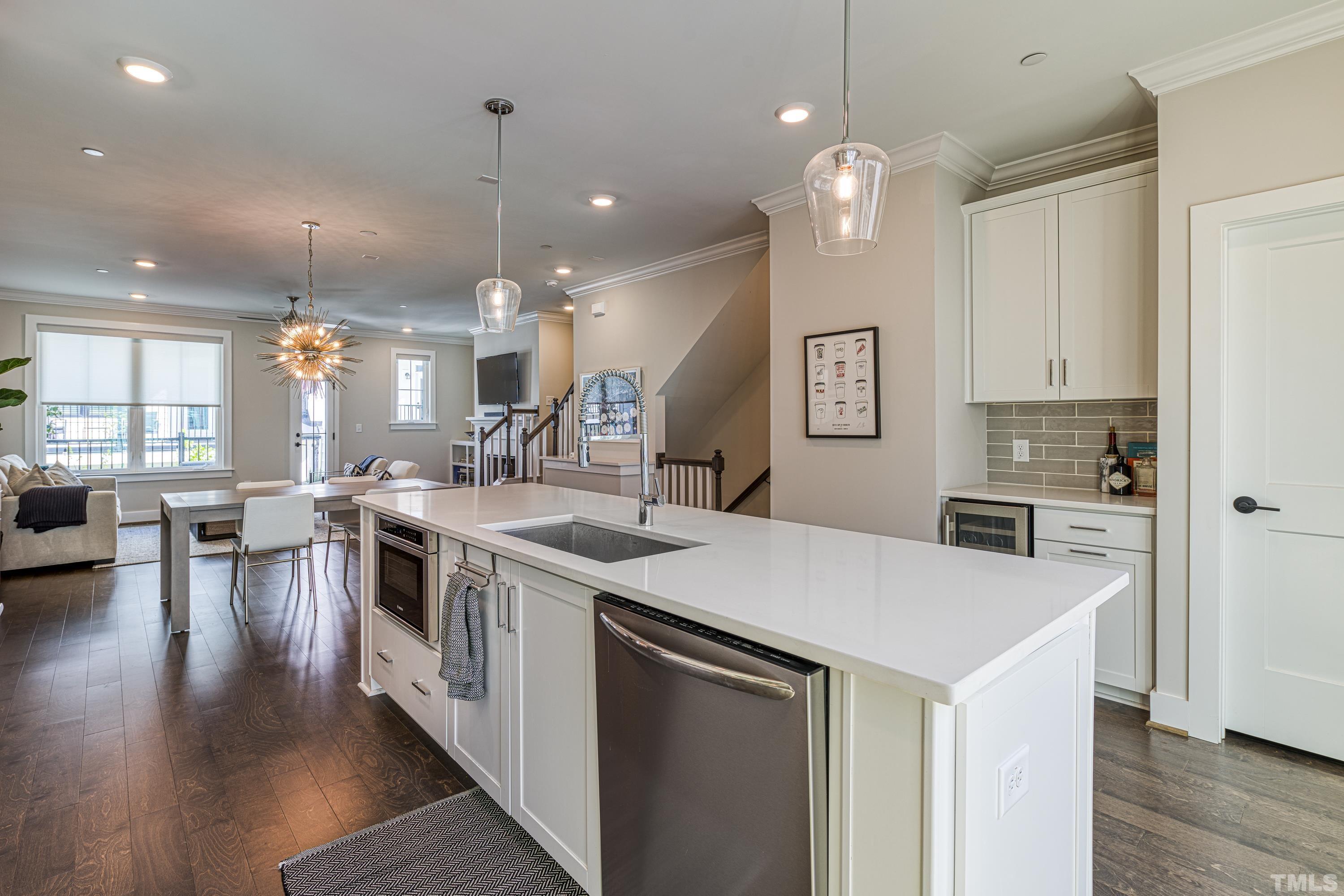 401 Bryan Pointe Drive, Unit 103 Raleigh, NC 27608 - Photo 14 of 33 a kitchen that has a lot of table and chairs