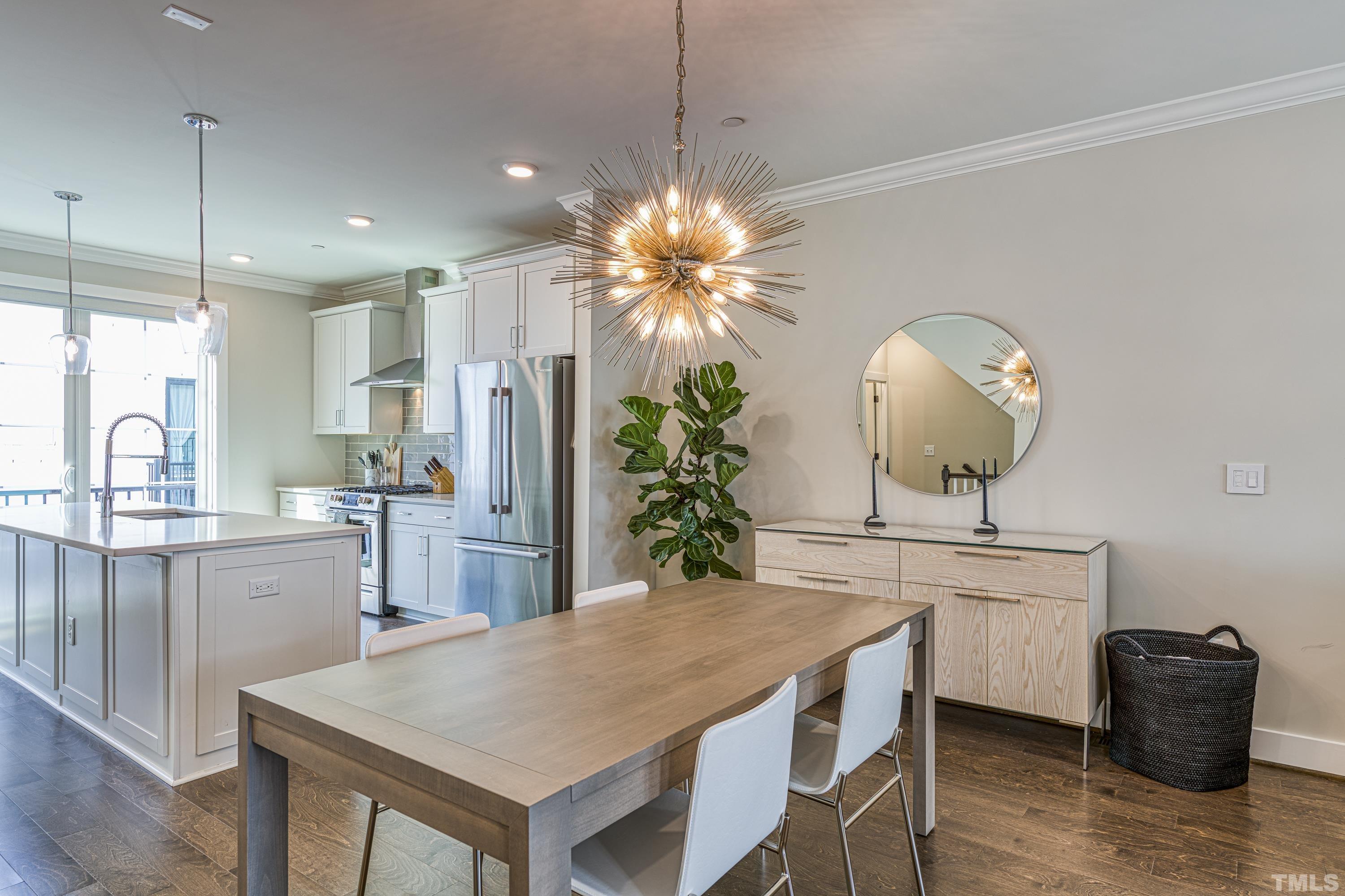 401 Bryan Pointe Drive, Unit 103 Raleigh, NC 27608 - Photo 15 of 33 a kitchen with a table and chairs