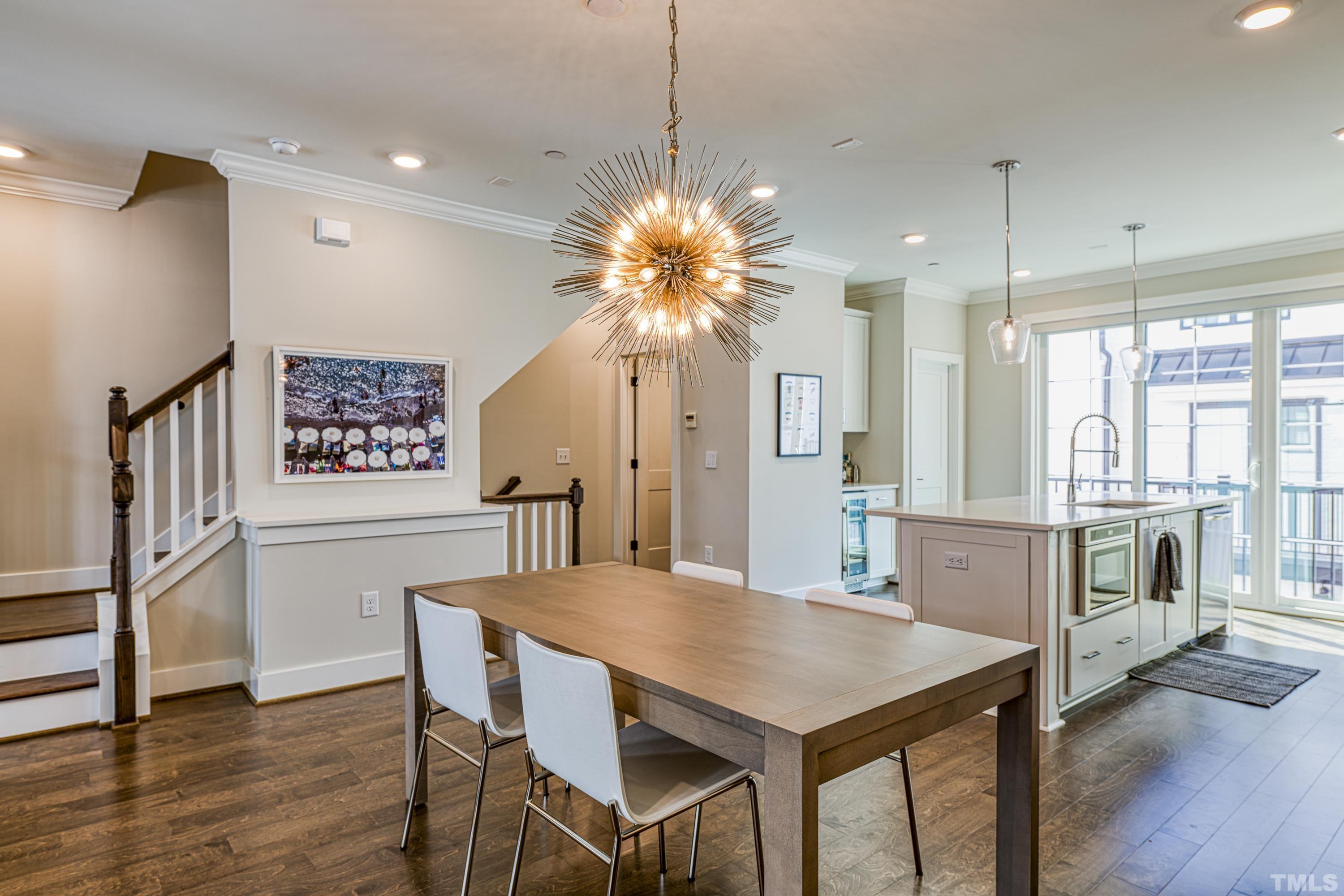 401 Bryan Pointe Drive, Unit 103 Raleigh, NC 27608 - Photo 17 of 33 a view of a dining room with furniture window and wooden floor