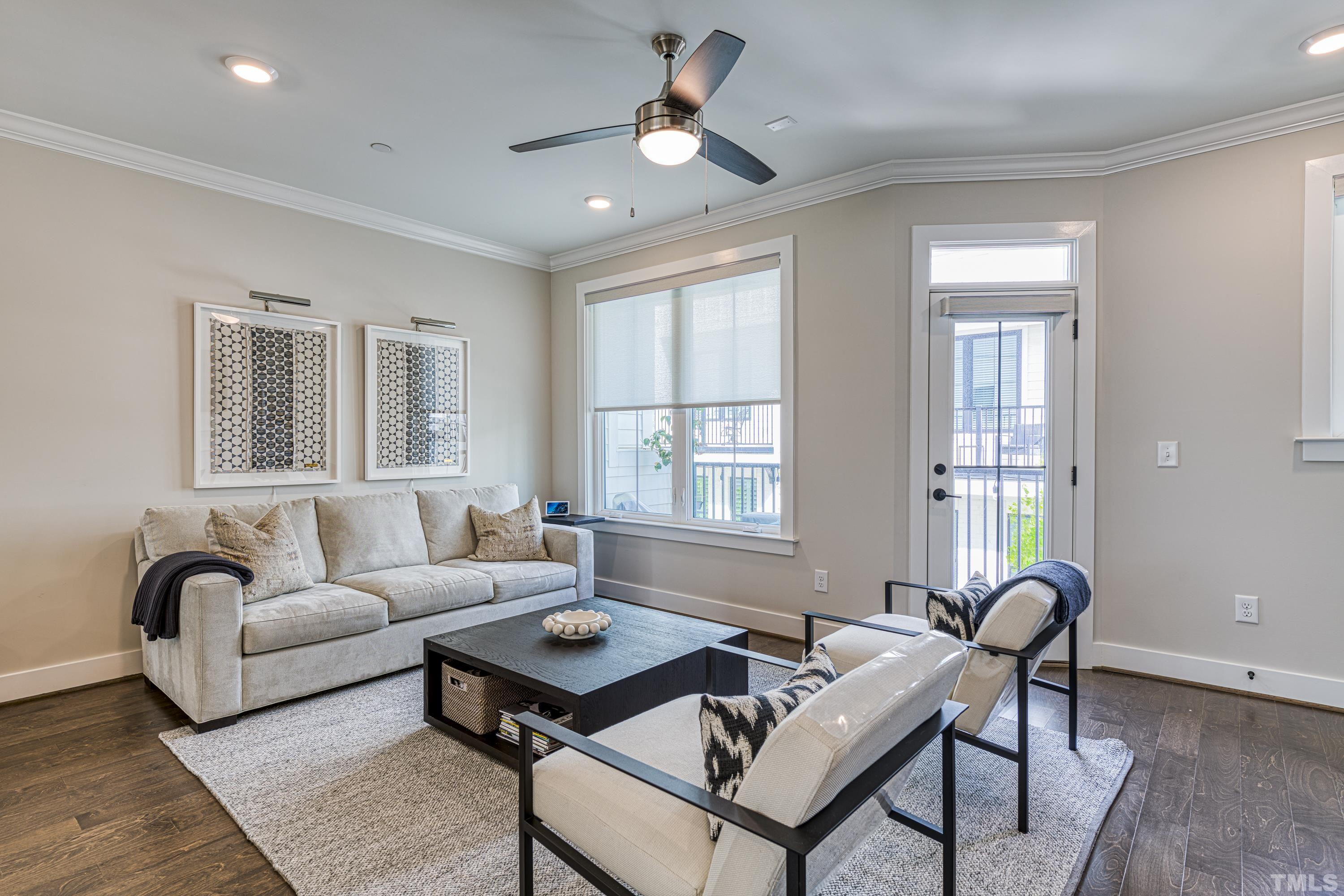 401 Bryan Pointe Drive, Unit 103 Raleigh, NC 27608 - Photo 19 of 33 a living room with furniture a chandelier and a window